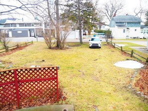 EXTERIOR:  The backyard parking area.