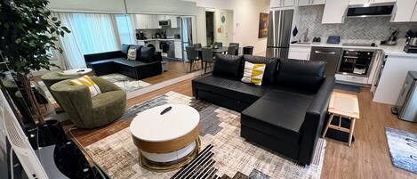 Living room with mirrored wall. Roller shades on the mirror to cover as needed.