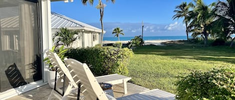 Outdoor private patio with two sun loungers overlooking the ocean.