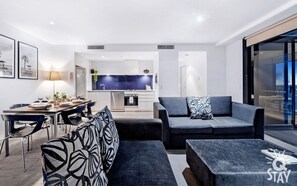 Spacious living room area overlooking the ocean and the city