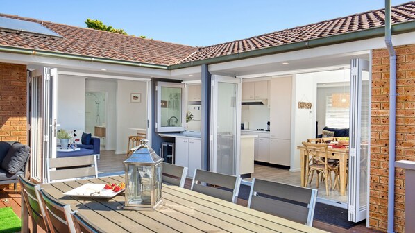 Latitude South Coast - accommodation jervis bay outdoor dining set looking into indoor lounge and kitchen