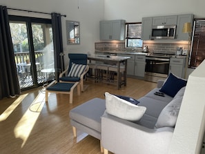 fully equipped kitchen with breakfast bar, dishwasher, refrigerator and stove