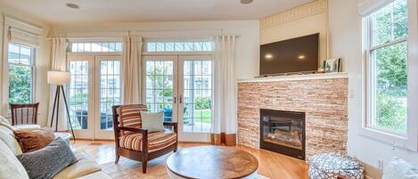 Aqua Essence has a cozy living room with flat screen TV and seasonal gas fireplace