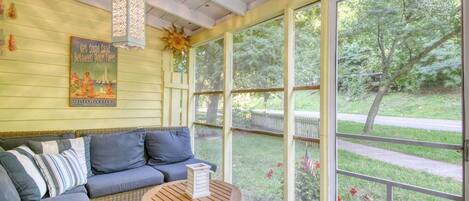 Relax on the porch of Sunshine Cottage as you watch the world go by