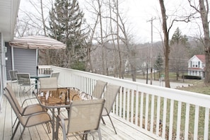 Deck with outdoor furniture overlooks the hill