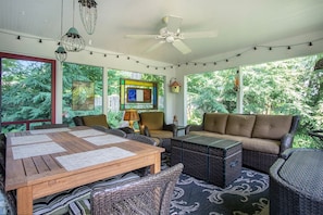 Wonderful screen porch with dining and relaxing furniture