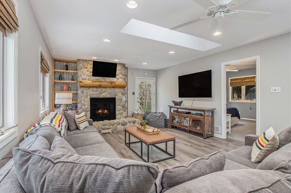 Cozy living room has a huge sectional sofa perfect for relaxing and watching the latest movie