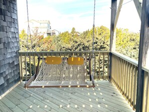 Chill on the double chair swing on covered deck off game room.