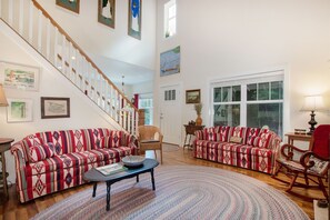 Open living room with two story ceilings