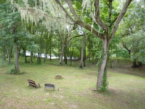 View from the "Treehouse" overlooking firepit, benches, and the Suwannee River