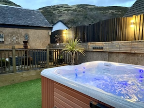 8 seater hot tub with private setting within garden. 