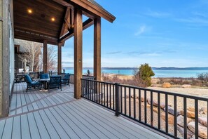 The back deck offers picnic areas, a large gas BBQ & stellar views of the lake.