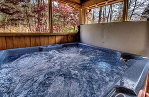 Enjoy relaxing in nature in your own private hot tub on a screened-in porch