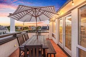 Perfect outdoor space for dining featuring a large reclaimed wood table.