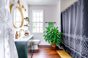 our spacious and well-equipped bathroom, featuring everything you need for a comfortable stay. From the bathtub for the little ones to the ample storage in the cabinetry, we've got you covered!