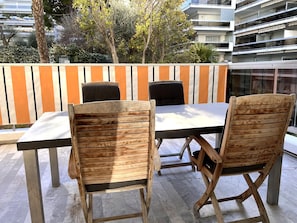 Terrace with lounge furniture and a dining table suitable for 6-8 people.