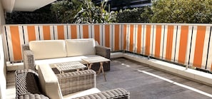 Terrace with lounge furniture and a dining table suitable for 6-8 people.