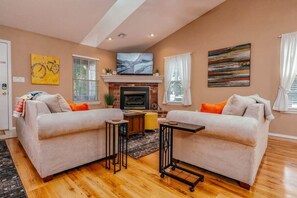 Cozy up and unwind in style at our living room, featuring a high-tech Smart TV, and plush oversized sofas - perfect for an evening of relaxation with family or friends.