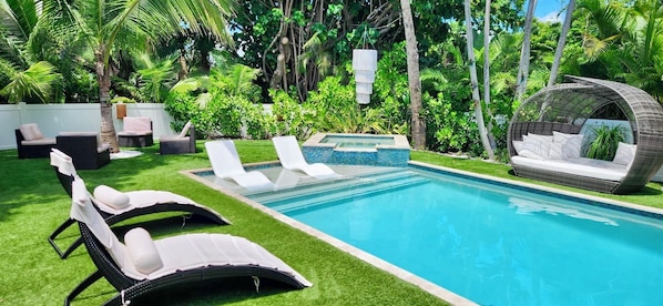 Lounge pool chairs in our backyard oasis