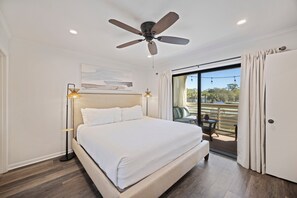 Primary suite with king bed, porch access, TV & private bathroom.