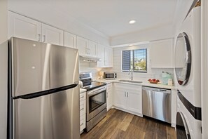 Fully equipped, modern kitchen with stainless appliances.