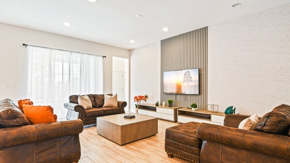 Chic modern retreat with cozy leather seating and stylish entertainment space.
