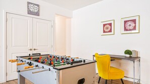 Fun-filled nook with foosball table and stylish workspace for work or play.
