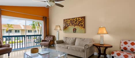 The living room is spacious with vaulted ceilings and overlooks the balcony where you can dine outside