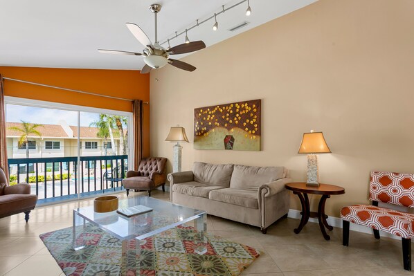 The living room has vaulted ceilings and overlooks the balcony.