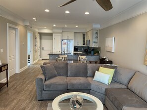 Living room in the foreground followed by the dining room and kitchen.