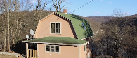 West end of house with scenic view to valley and village beyond.