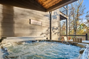 Let the bubbles take you away as you soak in this secluded hot tub under the trees.