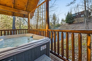 Hot tub with greenery views.