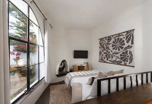 Sunken bedroom area with large windows to let in your afternoon light.
