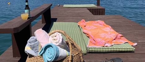 Deck with access to water, sun umbrella, cushions and beach chairs