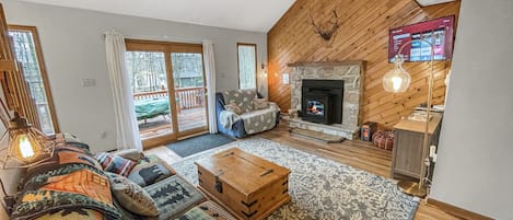 Spacious living room with pellet stove, Roku TV, comfy seating & door to deck.