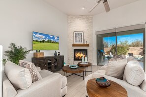 Cozy and Homelike Living Space featuring flat screen SMART TV, Indoor Fireplace and Designer Furnishings.