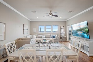 Gather around the farmhouse-style dining table with open sightlines to the kitchen—perfect for sharing meals and memories.