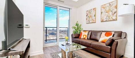 The living room features a 55" Smart TV and entrance to the patio.