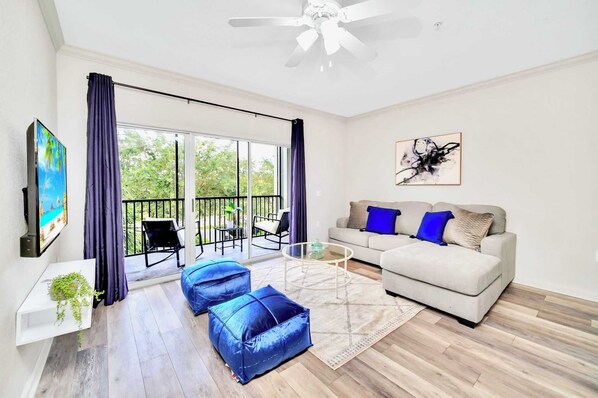 Inviting living room with smart TV and direct patio access