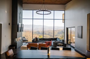 The vaulted wood ceiling adds warmth and charm to this elegant dining and living area. Perfect for gatherings and quiet evenings alike.