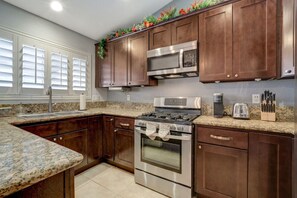 Cook your favorite meal in our fully equipt kitchen with views of the pool. Our kitchen has doors to the pool where the grill is so that it is east to prepare food to be grilled or set up a buffet to be served in the kitchen.c