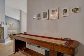 Full-sized shuffleboard table with Mirage memorabilia gallery wall. Memorabilia includes a signed Vegas Vacation photo by Randy Quaid, signed Terry Factor show ad, signed Danny Gans Show Program,  and vintage Mirage Hotel postcards.