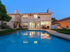 Private backyard with pool, patio seating, bbq and fire table