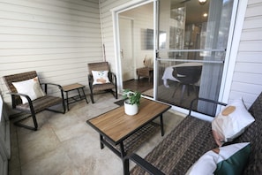 Enjoy fresh air and great conversation on the covered porch with comfy seating for everyone.