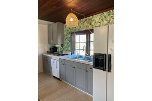 Kitchen includes a gas range/oven and plenty of cooking supplies.