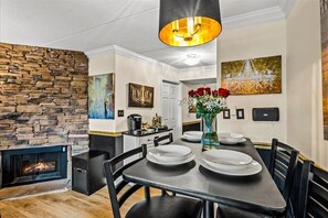 Savor a romantic meal at the elegant dining table, then cozy up by the warm glow of the fireplace for an intimate evening together.
