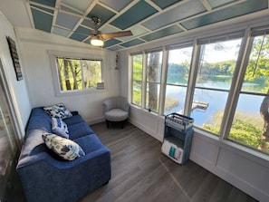 Sunroom facing the lake with queen size sofa sleeper.
