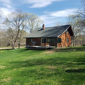 The lake side of the home with a patio and grill
