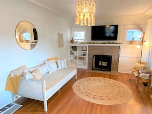 Smart TV, wood burning fire place, and plenty of Surfy style.